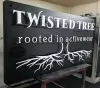 Twisted Tree Black and White Sign Curbside